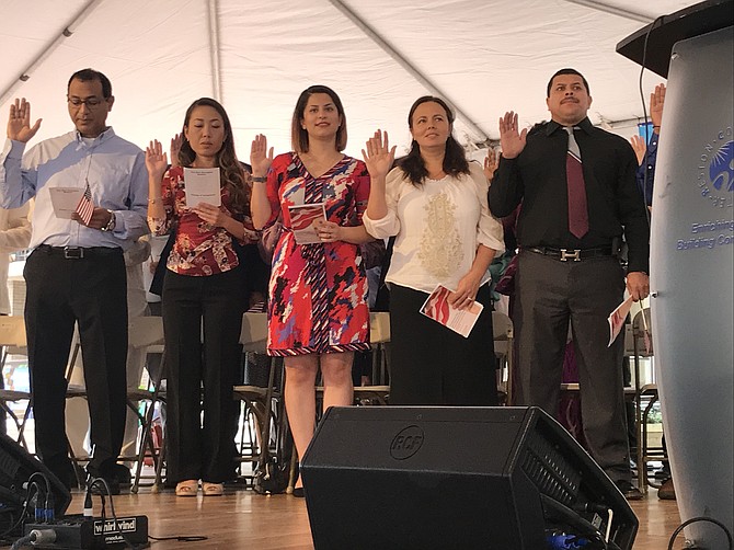 Candidates for citizenship of the United States read the Oath of Allegiance with Kimberly Zanotti, Washington Field Office Director, USCIS at the Naturalization Ceremony held during the Reston Multicultural Festival on Sunday, Sept. 23, 2018.