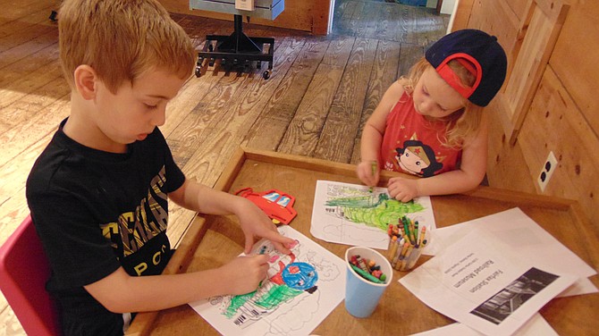Henry, 6½, and Sloan Speidell, 3½, color a train drawing at the Fairfax Station Railroad Museum.