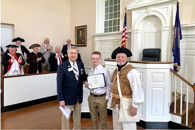 From left: Mike Weyler, Jacob Michael Duncan and Leamon Duncan. In background: Fairfax Resolves interpreters are giving Jacob a hand after his induction into the Virginia Society, Sons of the American Revolution at the historic Fairfax Courthouse.