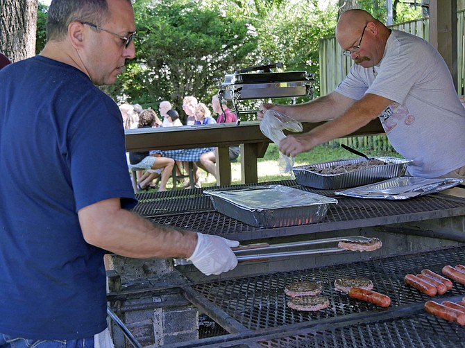 Daniel Valentini (left) and Kenny Goss, Knights of Columbus volunteers, barbecue hamburgers and hot dogs for the Thrive fundraising event on Saturday, Sept. 29.
