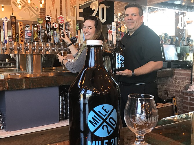 Phil Orme, owner of Mile 20 within the Mediterranean Breeze Restaurant checks one of the 24 taps with bartender Kati Simpson. The new craft beer and cider bar fills a void in the Herndon area for an extensive tap list, well-stocked cooler, and great beer and cider-friendly food all in one space.