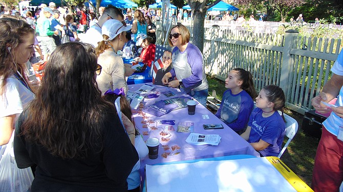 The booth for Shelane’s Run – A 5K race and 1K fun run, to be held on Saturday, Oct. 13, in memory of Shelane Gaydos of Herndon, who suffered from postpartum depression and committed suicide.