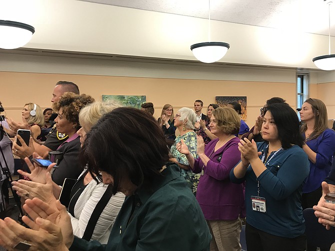 Attendees at the “Make the Call” panel presentation in recognition of Domestic Violence Awareness Month 2018 applaud Del. Kathleen Murphy (D-34) after she announces publicly for the first time: "I am a survivor. I was a victim of sexual assault in college. … I believe when we stand together, side by side ... and we can say it, out loud, 'We are victims of abuse’ ... we demonstrate we can move forward and win." 