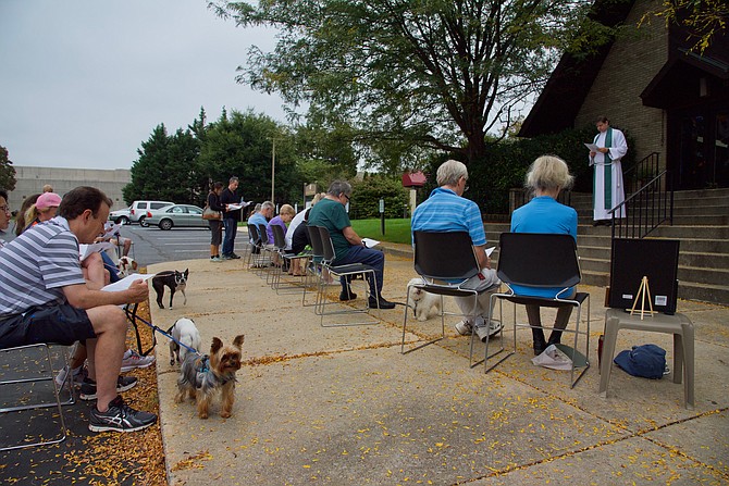 The Rev. James S. Isaacs leads the Blessing of the Animals Service at St. James' Episcopal Church, 11815 Seven Locks Road, on Sunday, Oct. 6. The service commemorates the feast day of St. Francis of Assisi, the patron saint of animals, the environment, and religious cooperation. See www.stjamespotomac.org.