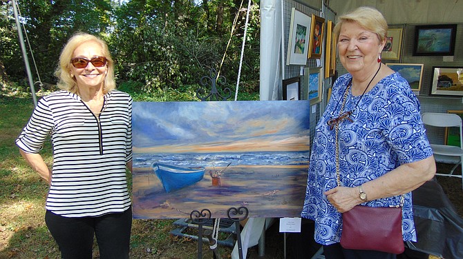 McLean Art Society Past President Judith Landry with her “Beached at Sunset” oil on canvas with Luda Del Rose, Treasurer.