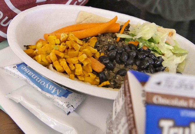 This compostable tray has a been loaded with beef, rice and sweet potatoes — colorful as well as nutritious — by a student who says she loves being able to choose what she wants instead of having someone hand her a portion of something — and it’s also delicious.