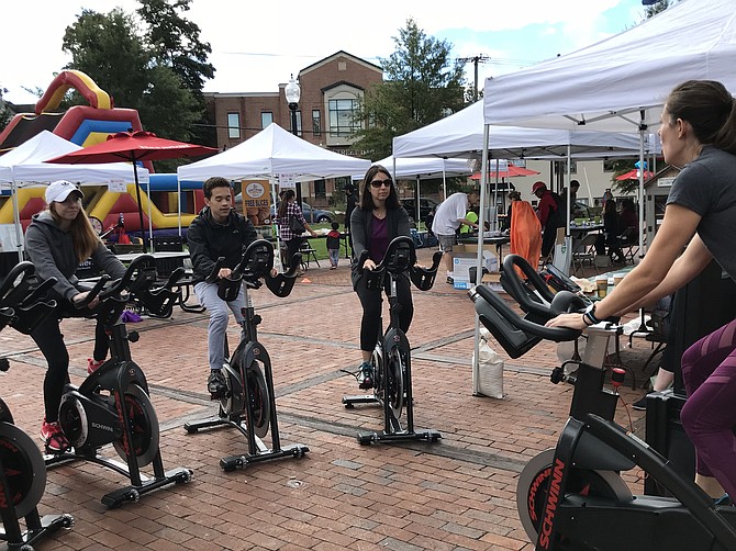 At the second Annual Family Fitness & Fun FEST, visitors hop on bikes provided by New Trail Cycling Studio, Reston and set off on a workout to the beat of music recharging toward a healthier way of life.