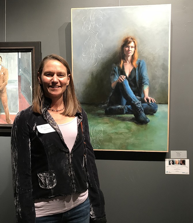 Samantha Hand stands beside her portrait, "Kimberly," awarded First Place in the 10th Annual Expressions Portrait Competition/Exhibition by Arts Herndon held Oct. 13, 2018.