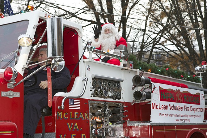 Santa Claus rode on top of the McLean Volunteer Fire Department’s fire truck in the 2016 McLean WinterFest parade.