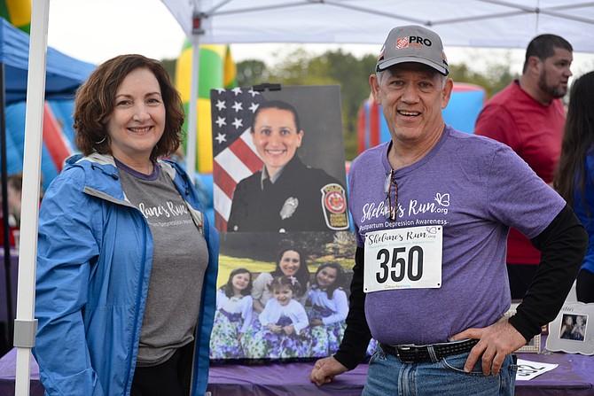 Joanne and Steve Bryant, the parents of Shelane Bryant Gaydos, pose with photos of their daughter and her children at the 3rd Annual “Shelane’s Run” charity race. Shelane died of suicide while suffering from maternal mental health issues and her family will “honor her memory and help others to avoid that tragedy.” 