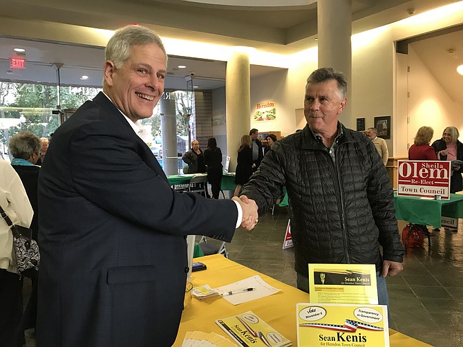 Candidate Sean Kenis greets Paul Richards of Herndon during the Herndon Town Council Candidate Meet & Greet hosted by the Dulles Chamber of Commerce on Monday, Oct. 22, 2018.
