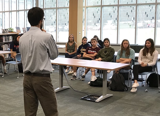 Forsthoefel leads an AP Psychology class in Langley’s library during the day’s first breakout session. In a circle, Forsthoefel asked students to share the name of a person for whom they chose to dedicate their “walk,” or their day.