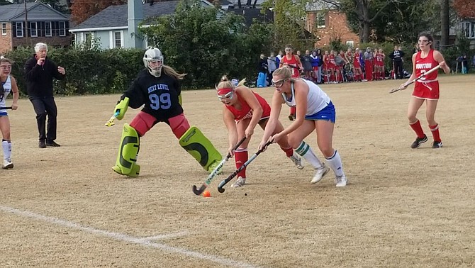 Churchill’s Alex Sperling, right, and Wootton’s Grace Henschel compete for the ball during Monday’s playoff game at Churchill High School.
