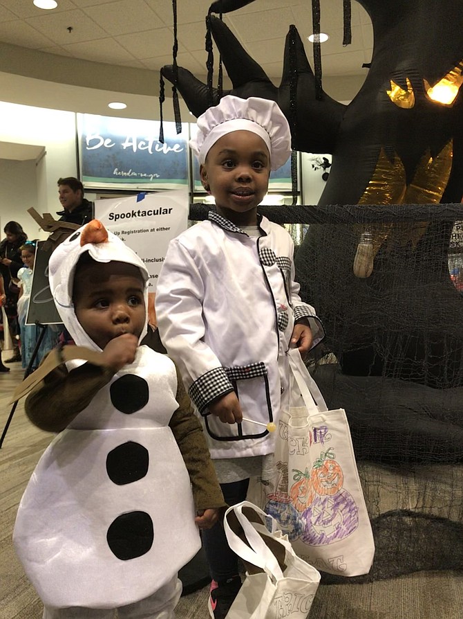 A haunted tree with glowing eyes is no threat to the brave of heart as Omari Barbour, 1 1/2 of Herndon, and his sister Naima, 4, get up close to the ghoulish tree at Spooktacular produced by Herndon Parks and Recreation.