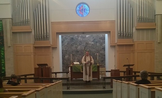 At the 11 a.m. traditional Sunday worship service Oct. 28 in Centreville United Methodist Church at 6400 Old Centreville Road, lead pastor Rev. Will Montgomery prays for the victims and survivors of a mass shooting at a synagogue the previous morning in Western Pennsylvania, where a gunman entered the Tree of Life Congregation in Pittsburgh and killed 11 people and wounded 6.
