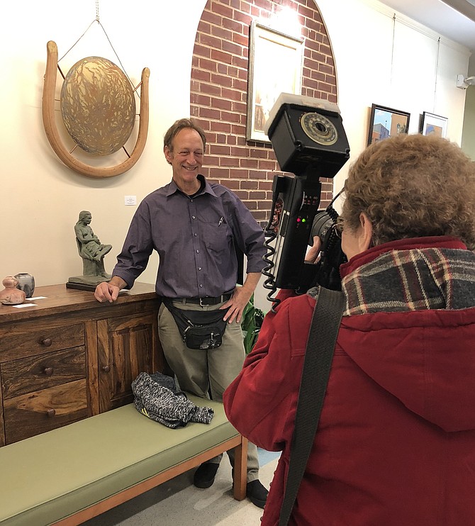 Best known for his photography, artist Steven Halperson has been etching copper for many years. Here he is with his mother, photographer Nina Tisara, in front of his entry “Tree of Life,” framed in an old chair back.