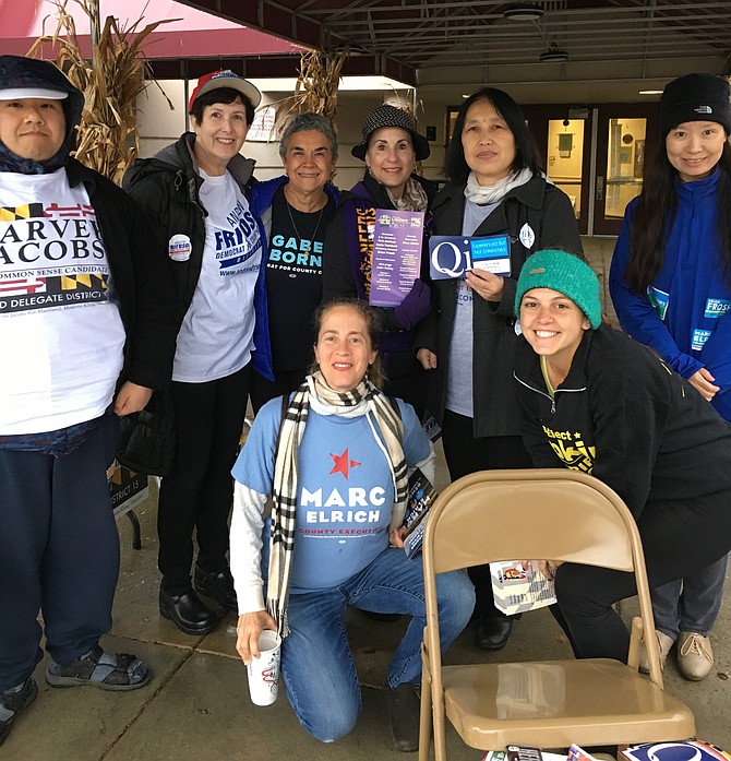 Volunteers greeted voters as they arrived at Potomac Community Recreation Center Tuesday. This group is mostly Democratic but Alex Moi, left, was sharing literature for Republican Harvey Jacobs.