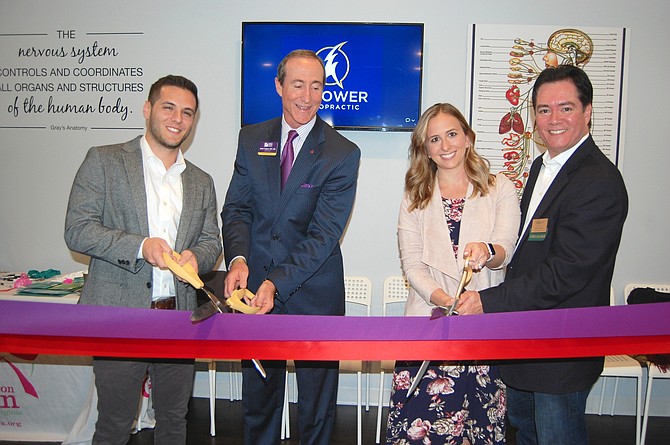 Empower Chiropractic holds double ribbon cutting ceremony with Reston and Tysons Chambers of Commerce. From left: Dr. Evan Lichtenauer, co-founder Empower Chiropractic; Marc Ingrao, president and CEO, Reston Chamber of Commerce; Dr. Callan Lichtenauer, co-founder Empower Chiropractic; and Chris Tomseth, vice president, marketing, Tysons Regional Chamber of Commerce.