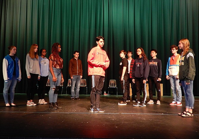 Trying to discern who killed Wellington, the dog, the autistic Christopher (played by Danny Villalobos, in center) approaches neighbors he’s never spoken to before.