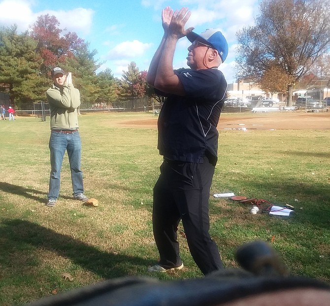 Mount Vernon Mavericks coach Rene Belanger demonstrates stretching exercises with a group of FHLL coaches. Belanger has been involved in local baseball — little league to high school varsity and beyond — for decades.