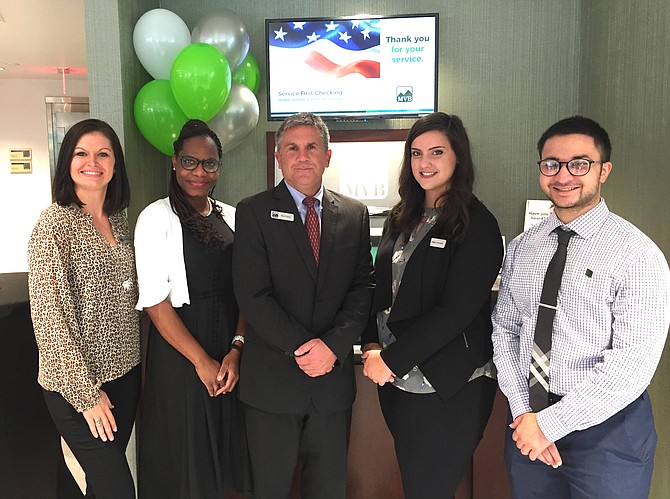 Kevin Corey, third from left, manager of MVB Bank’s newest banking center in McLean, and his team show off their brand-new facility and the latest in banking technology, the Interactive Teller Machine. From left, Whitney Woofter, Claudia Wray, Corey, Blake Ferrante and Ali Zaidi.