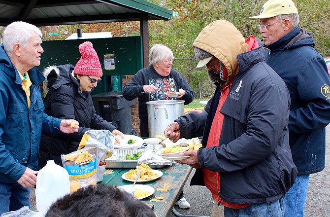 Barb Keish dishes up Margaret Miller’s (hat to left) famous hot ham chili with extra peppers for the bimonthly lunch prepared and served by members of Rock Spring UCC.