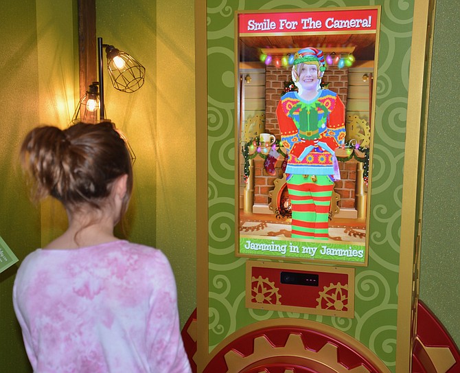 Eight-year-old Charlotte from Fairfax Station checks out her elf look in Santa’s Magic Mirror.