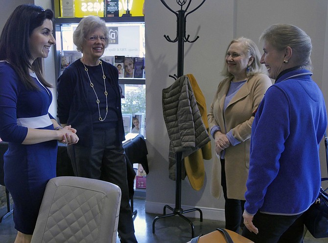 Dr. Sheri Salartash (left) and Janice Curtin, president of the Alexandria chapter of (WAPF) chat with members before the lecture on Nov. 11.