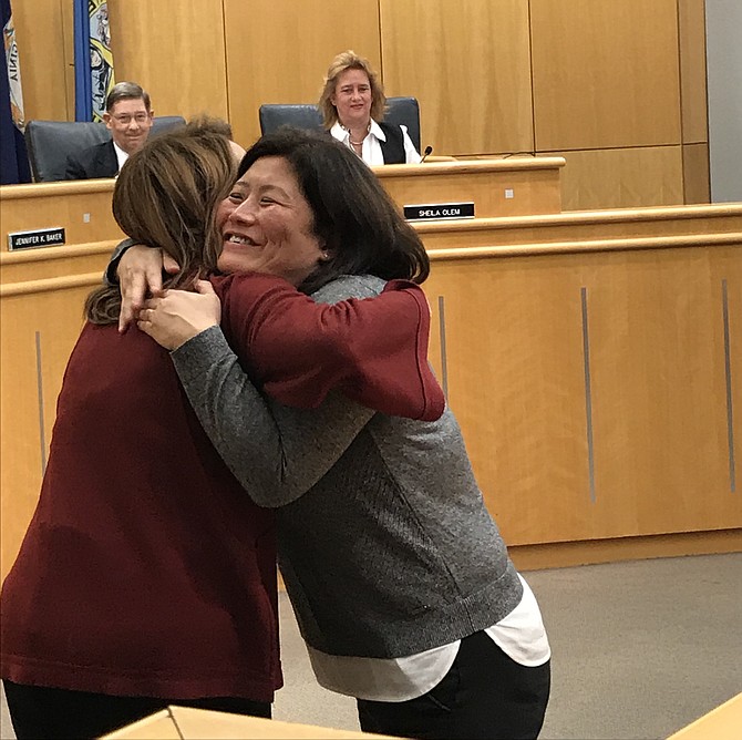 Sunny Howe, recipient of the Town of Herndon 2018 Good Neighbor Award, gets a hug from Lisa C. Merkel Mayor of Herndon during the award presentation Tuesday, Nov. 13 during the Town Council Public Session.