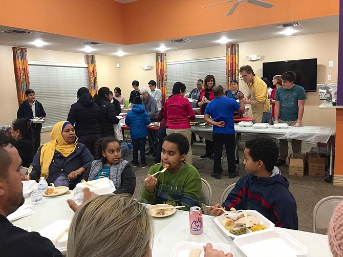 Arlington Housing Corporation (AHC) affordable housing residents enjoy Thanksgiving dinner cooked and served by local volunteers.