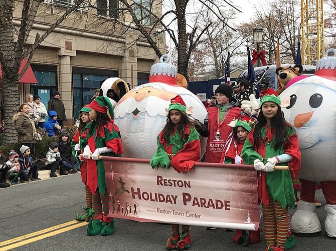 The sight and sounds of the 28th annual Reston Holiday Parade kicked off with the official banner and characters.