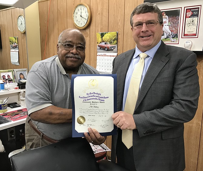 Al Glaeser, Worshipful Master of Mount Vernon Masonic Lodge No. 219, presents the Community Builders Award to Art Blakey of the Hollin Hall Barbershop.