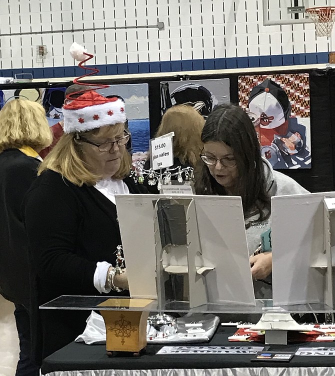 Celia Benz designs her own one-of-a-kind crystal charm bracelets with a little help from Lori Hentschel, co-owner with Sandy LaBoon of Sandori Jewelry, a local business, during the Herndon Holiday Arts & Craft Show held Sunday, Dec. 2.