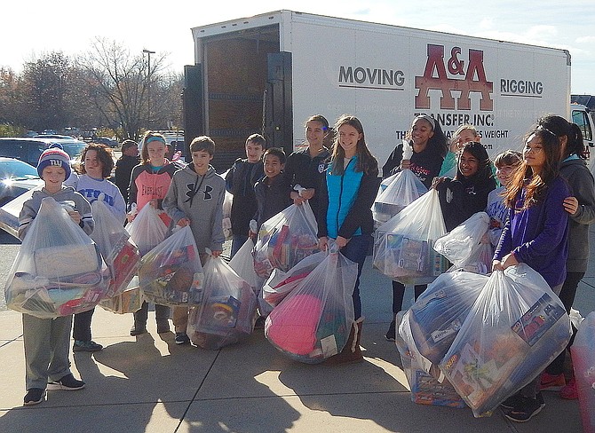 Students load donated clothing into a truck for transfer to ONC’s warehouse during last year’s gift-drive collection.