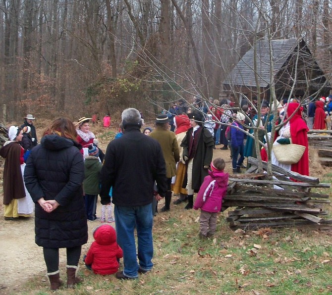 Visitors speak with docents at Claude Moore Colonial Farm in McLean.