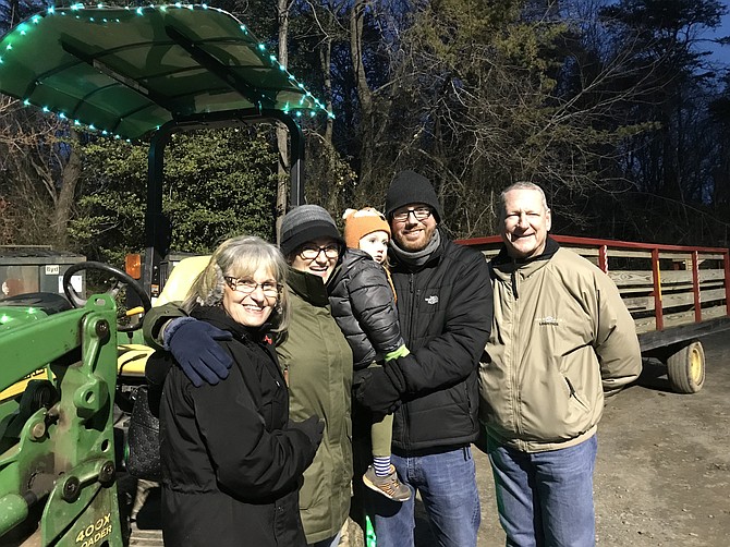 As the tractor-driven Starlight Express at Lake Fairfax prepares to load, the Schroeder family of Springfield, April, Harper 2 1/2 and Shane (center) pause to capture the moment with April's parents, Cindy and Chip Paris of Wooster, Ohio (far left and right).