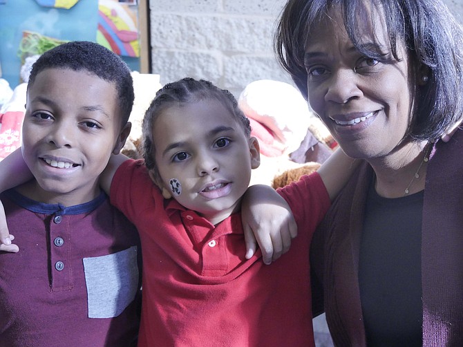 Twila Mack and her two adopted sons, Ben and David, are attending the annual Arlington County Department of Human Services Adoption/Foster Care Holiday party at Kenmore Middle, School Dec. 8.