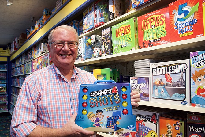 Brian Mack, owner of Toy Castle, displays popular game Connect 4 Shots.