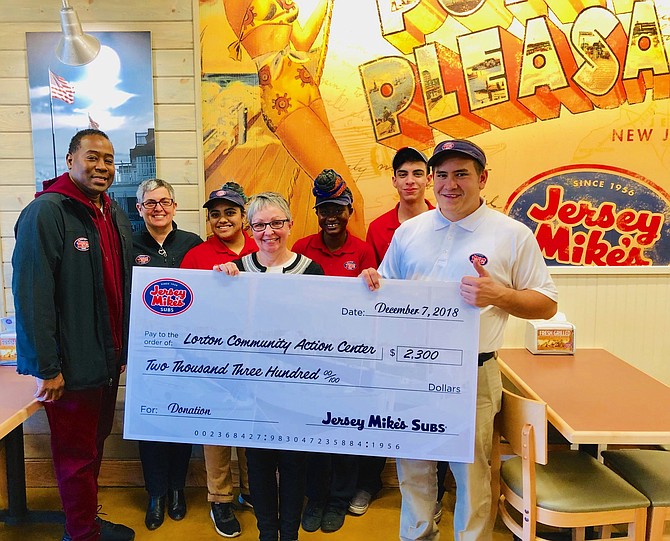Jersey Mike’s Subs of the Shoppes at Lorton Valley presents a check for $2,300 to Executive Director Linda Patterson of the Lorton Community Action Center charity. Pictured from left: Maurice Jennings, Tracey Jennings, Roxanne Coreas, Linda Patterson, Ramatu Williams, Eslam Hassan, and Donnie Otero.