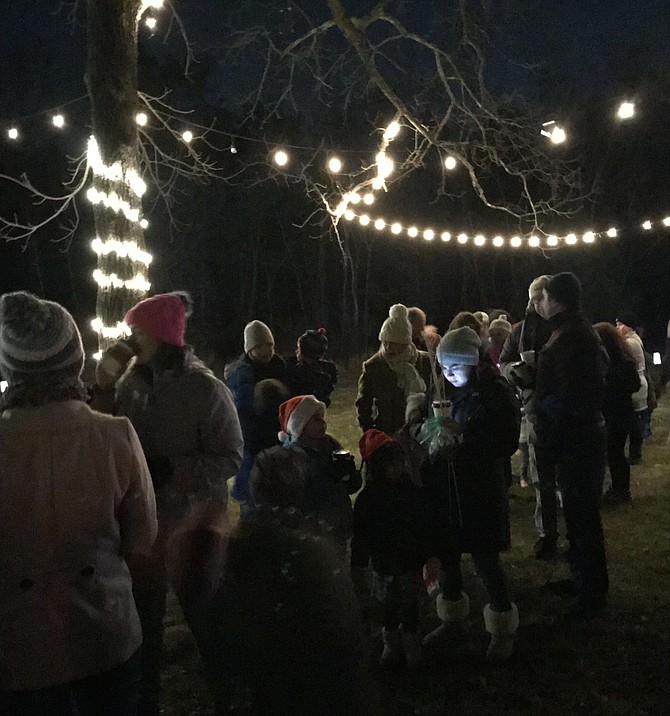 Families line up under the twinkling lights for a personal chat with Santa during the 2nd Annual Santa, Stars, & S'mores held at Runnymede Park in Herndon.