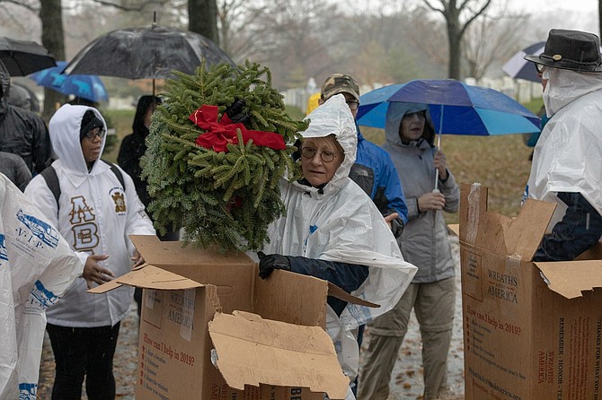 A volunteer unloads a wreath during Wreaths Across America day Dec. 15 at Arlington National Cemetery.