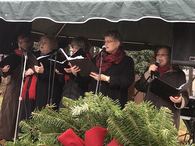 Members of the Bobby Pins, a group within Reston Chorale, (from left) Ellen Torzilli, Jo Marshall, Kate Schindler, Susan Wagoner, Kit Kobran and (not pictured) Al Torzilli sing as participants place wreaths on veterans' gravesites.