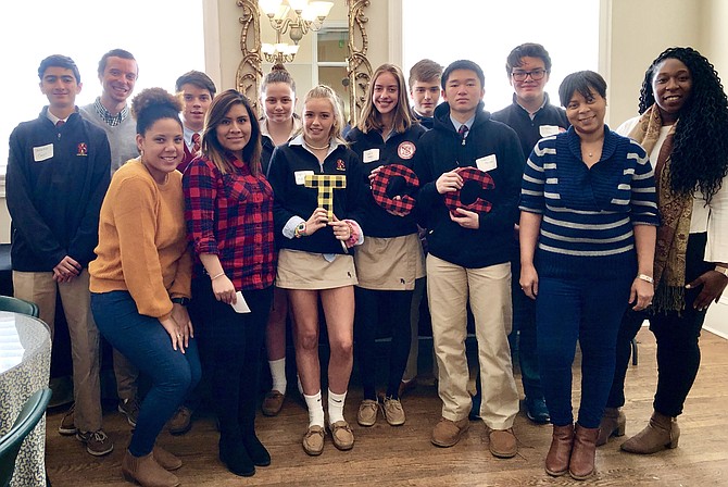 Bishop Ireton High School students pose for a photo with Campagna Center employees as part of their volunteer service Dec. 6 during We Care Week. Among the Bishop Ireton students are: Jonathan Cassin '21, Sophia Matiunas '21, Sierra Peters '21, James Nguyen '21, Jacob Aills '21, Jessica Armstrong '21, William Oakeley '21, and Dayton Crowley '21.