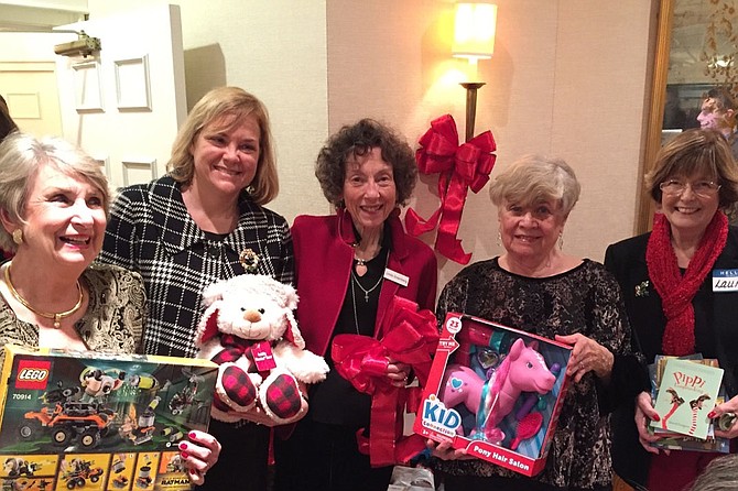 From left: Susie Miller, Susan Fitzpatrick of Community Lodgings, Linda Greenberg, Lois Lipson, and Laurie Kirby as they show a few of the gifts being contributed to the client families of the local non-profit by Commonwealth Republican Women’s Club.