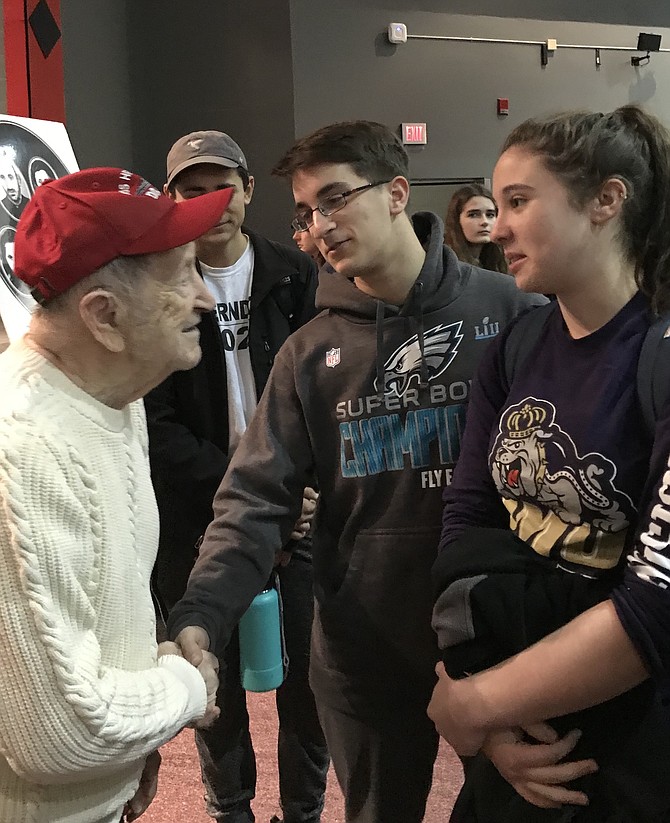 Mathew Steil, 17, and Zoey Birman, 16, Herndon High School Band members, thank Rubin Sztajer, Holocaust survivor for coming to speak to The Pride of Herndon before the students’ upcoming spring trip to Normandy for the 75th Anniversary of D-Day.