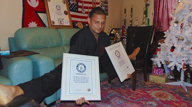 Three-time Guinness World Record holder Ujjwal Sharma Thakuri of Springfield does a Van Dam-style split in his living room.