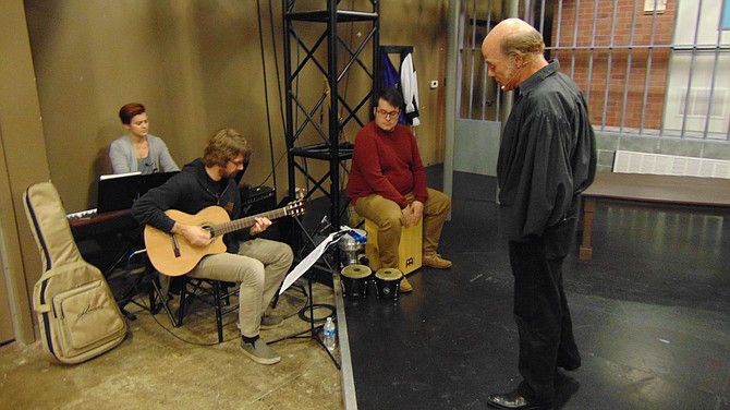 John Hollinger, who plays Cervantes in “Man of La Mancha,” rehearses a song with the band.