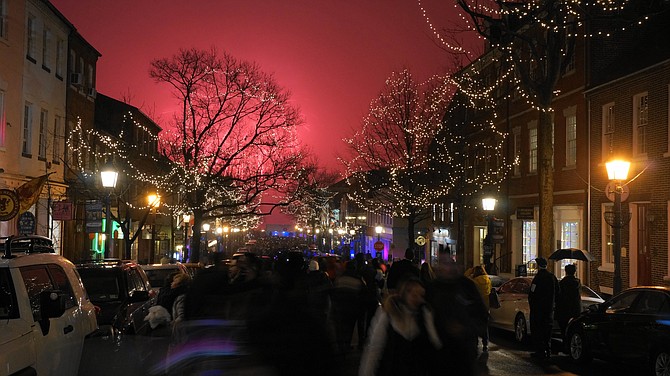 The First Night Alexandria fireworks turned the low cloud cover above the waterfront a fiery shade of red as revelers rang in the New Year at the foot of King Street.