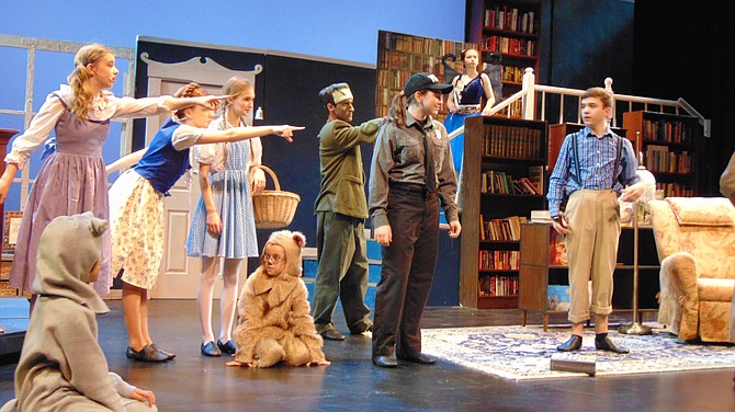 The cast rehearses a scene from Encore Stage & Studio’s production of “The Enchanted Bookshop.”