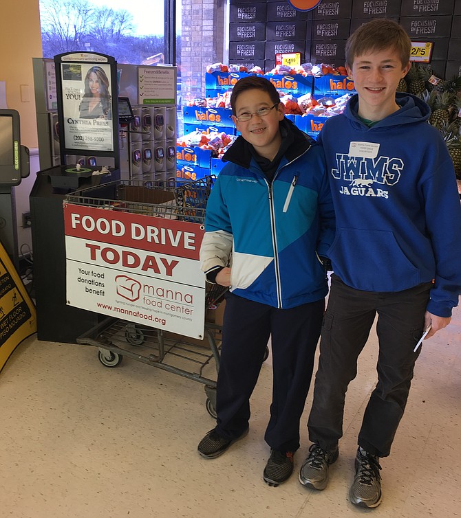 Ryan Whittaker, left, and Sean Borsum greeted shoppers at the Cabin John Giant last year, encouraging donations to Manna Food Center. The boys, both students at Julius West Middle School, volunteered as part of the Montgomery County Day of Service in honor of Dr. Martin Luther King Jr.